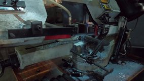 footage of metalworking equipment, bandsaw machine, closeup metal processing