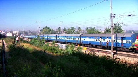 BANGALORE, KARNATAKA, INDIA - DEC 12, 2007 Indian passenger train passes by suburbs of Bangalore.