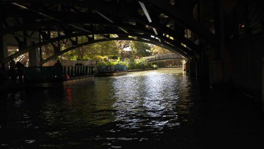 Riding Under Bridge at River Walk San Antonio Dark to Light