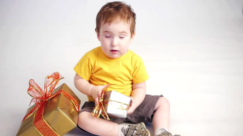 little boy opening a little gift