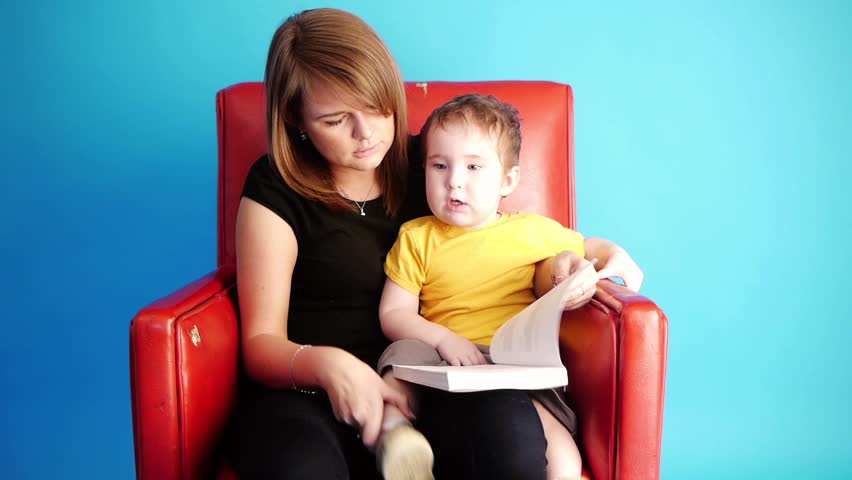little boy with a young woman reading a book together