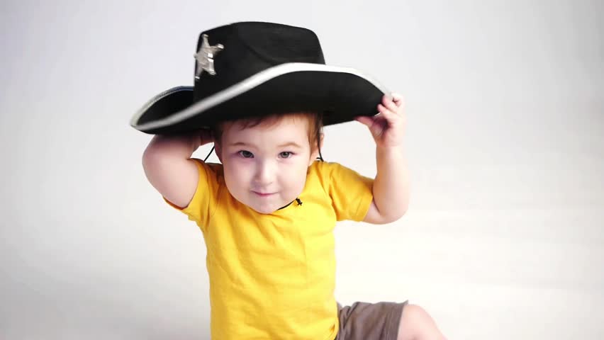 little boy with officers hat
