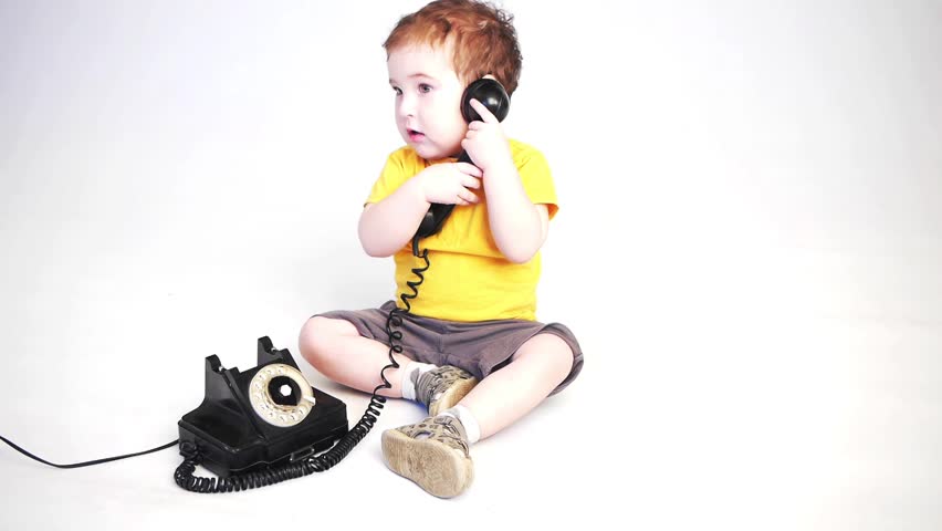 a child playing with an old phone in studio