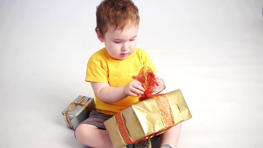 boy playng with gift boxes