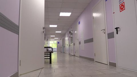 Hospital empty hall corridor with cabinets, wards and doors