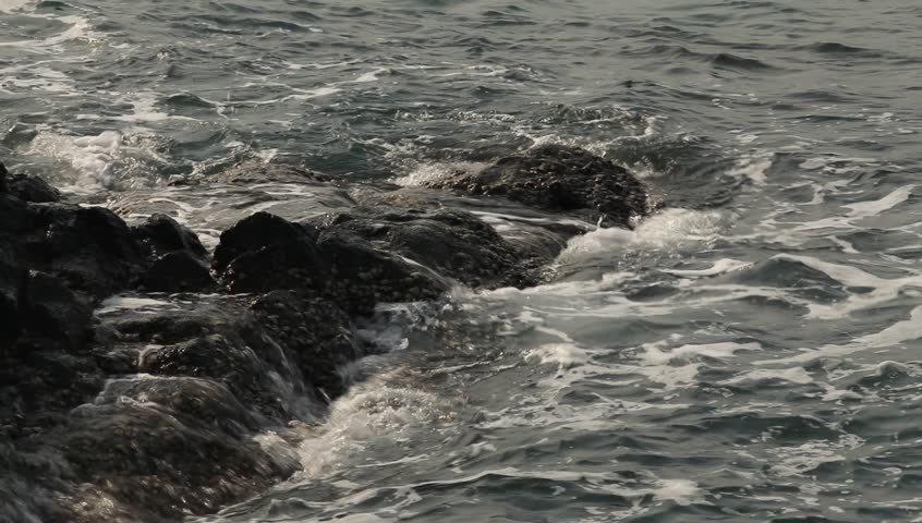 Close-up, sea waves on the stone wild beach (HD)