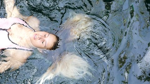 birds eye view of attractive beautiful young woman swimming
