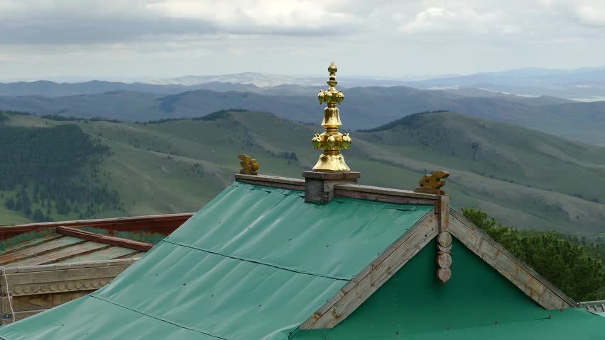 Arkhangai, MONGOLIA - July 25, 2017. The roof of an ancient Mongolian monastery in the background of mountains and a cloudy sky. Tovkhon Monastery. 