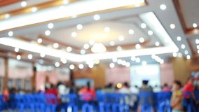 Blurred of Audience listening speaker speech in conference hall or seminar room with blur light people background.