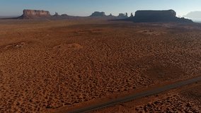 Bird's eye video from flying drone of beautiful endless scenery of Monument Valley desert and cloudless sky on horizon