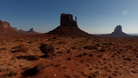Aerial view footage of beautiful natural Monument Valley landscapes.Panoramic video from drone of high cliffs and cloudless sky at sunny day