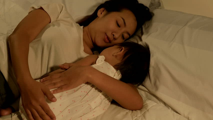 4k of Asian mother telling a story to her baby and lovely baby sleeping in ...