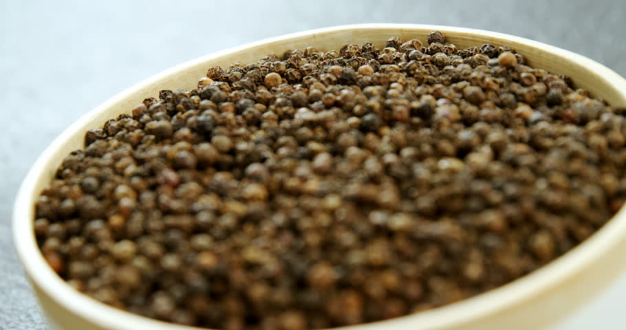Close-up of black peppers in bowl 4k