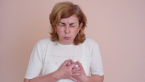 Woman with heart attack holding her chest