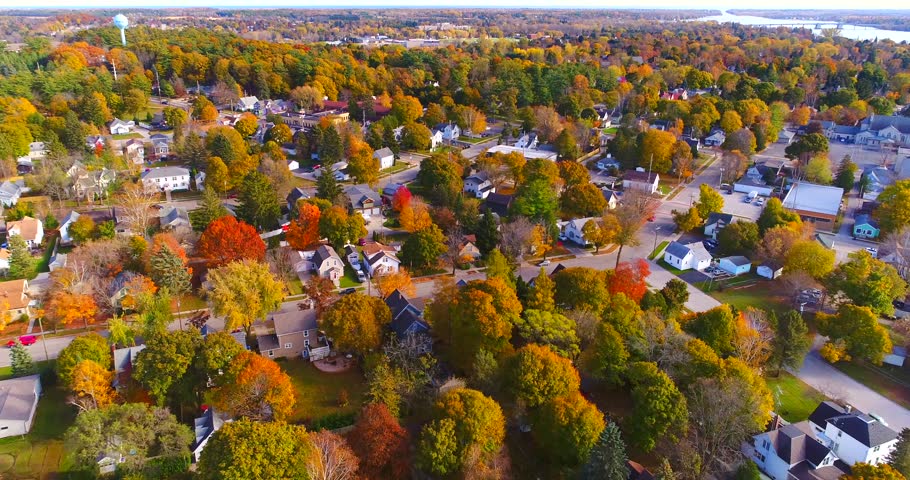 Colorful neighborhoods of Sturgeon Bay, Wisconsin, Autumn aerial flyover.
