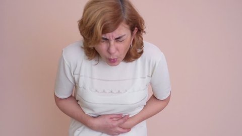 Woman with stomachache holding her stomach