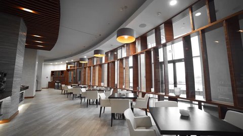 Video panorama of the cafe, tables and lamps, big windows, cozy atmosphere at the restaurant, interior design