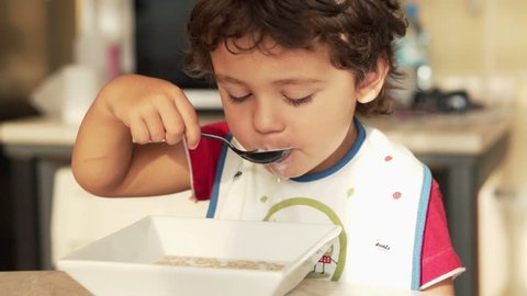 Kid eating milk with cereals, super slow motion, shot at 240fps
