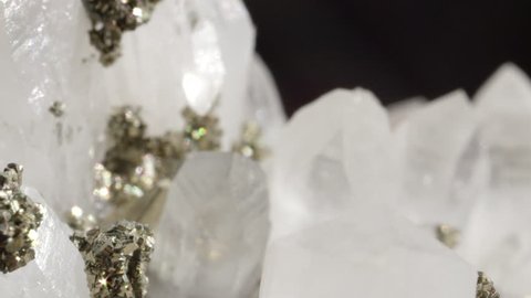 MACRO DOF: Beautiful shiny white quartz stone in combination with golden pyrite. Glimmering opaque quartz with metallic pyrite creating a beautiful image. Shiny gemstones forming a beautiful sight.
