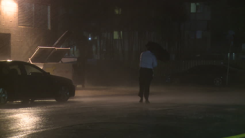 DARWIN, AUSTRALIA - FEBRUARY 2011. Torrential Rain Lashes Man In Tropical Storm - Full HD 1920x1080 30p shot on Sony EX1.  Royalty-Free Stock Footage #3362150