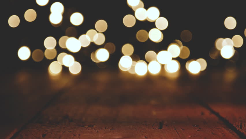 Reflections of Christmas lights with Bokeh effect on wooden Background | Shutterstock HD Video #33621523