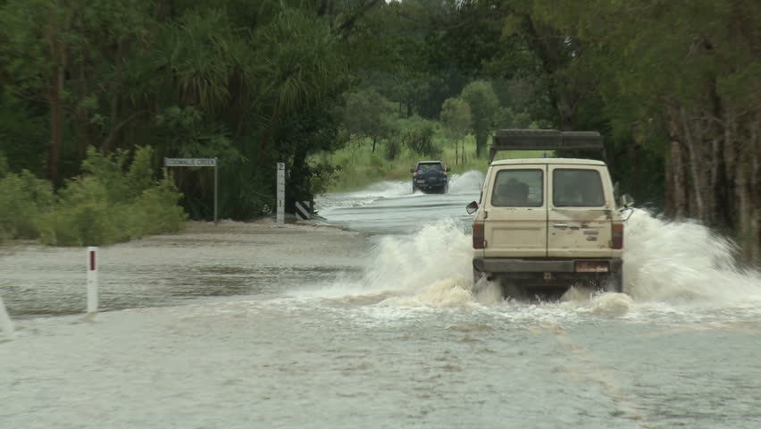 DARWIN, AUSTRALIA - FEBRUARY 2011. Car Drives Through Flooded Road - Full HD