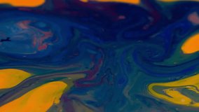 Colorful paint ink diffusion liquid movement Full HD video abstract background. stains splash flowing on color surface. Blue yellow formations floating on inky water