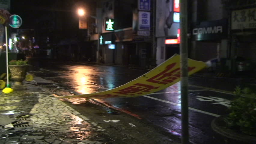 HUALIEN, TAIWAN - AUGUST 2009: Debris Flies Down Street In Hurricane At Night.