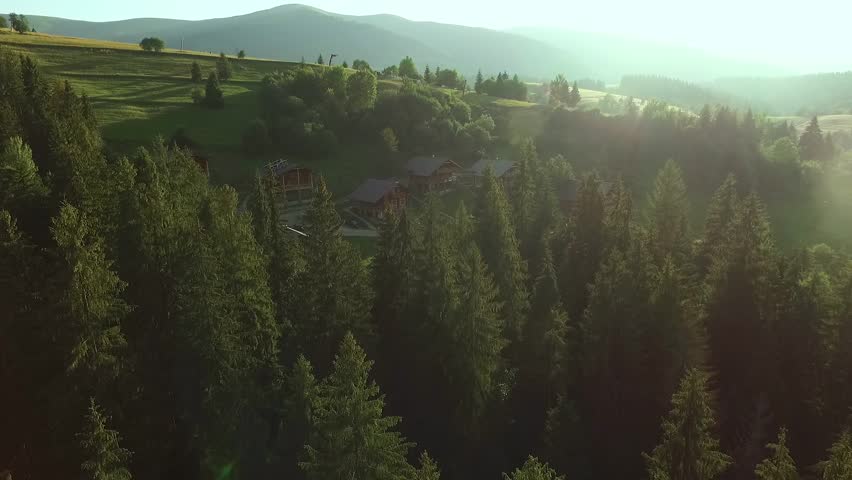 Sunlight illuminates the mountain landscape and the village.