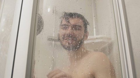 16Guy. pours water on shower cabin in slowmotion. hd00. 