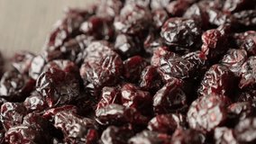 Pile of dehydrated red cranberries on table slow pan 4K 2160p 30fps UltraHD footage - Shallow DOF Vaccinium oxycoccos dried berries 3840X2160 UHD panning  video