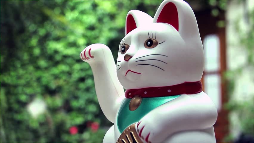 White Lucky Cat, Maneki-neko, on Green Background. Close-Up. Zoom In.  Royalty-Free Stock Footage #33639964