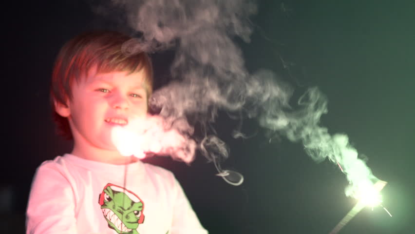 A little boy is a child playing with Bengal fire.