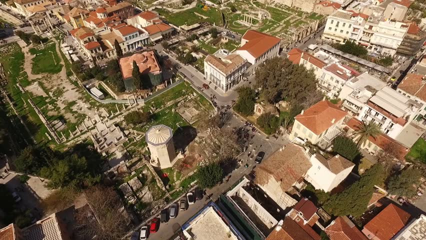 Aerial birds eye view video taken by drone of iconic archaeological sites in Plaka district, Athens historic center, Attica, Greece