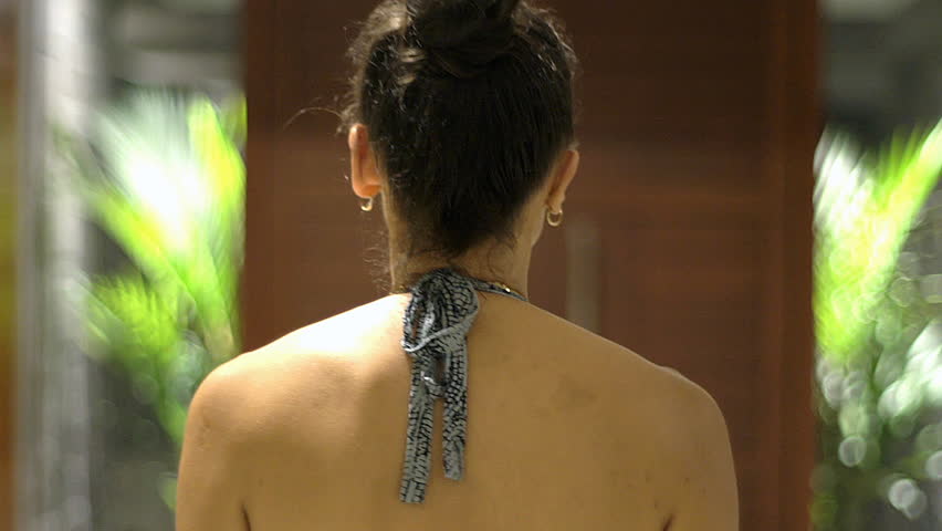 Attractive woman walking back in her flat and goes outside, steadycam shot
