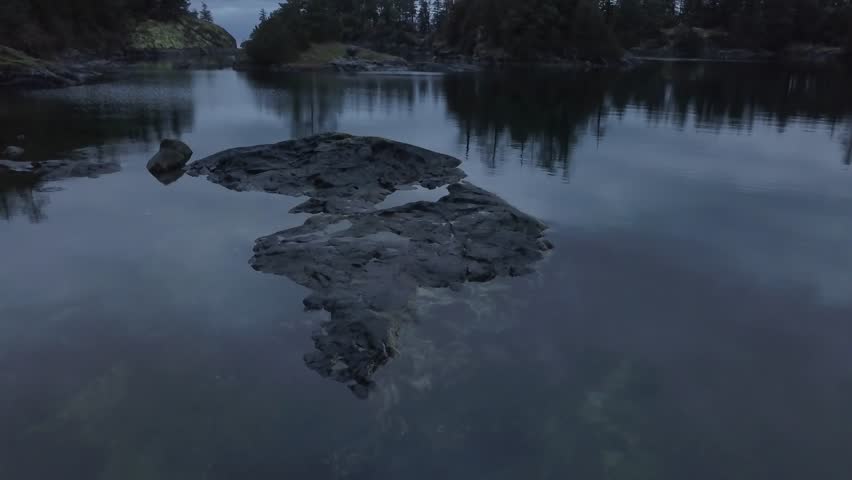 Aerial 4k drone footage of the beautiful Canadian Landscape on Pacific West Coast during a cloudy and rainy evening. Taken in Smugglers Cove, Sunshine Coast, British Columbia, Canada.