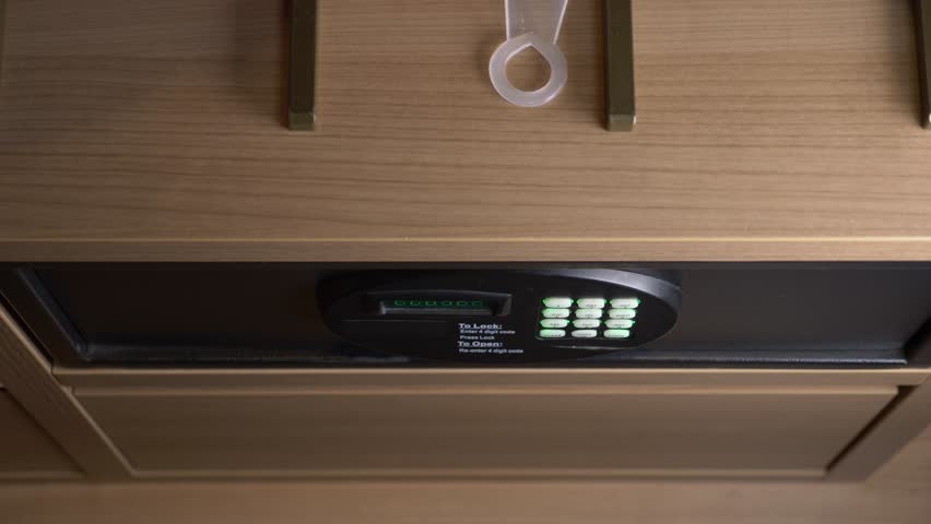 Opening the safe with a combination of numbers by hand and entering the code. 4k