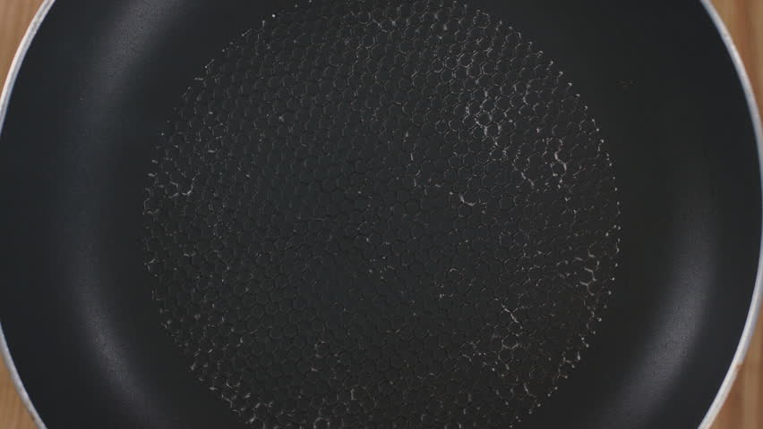 lose up os sunflower oil is poured onto a heated pan