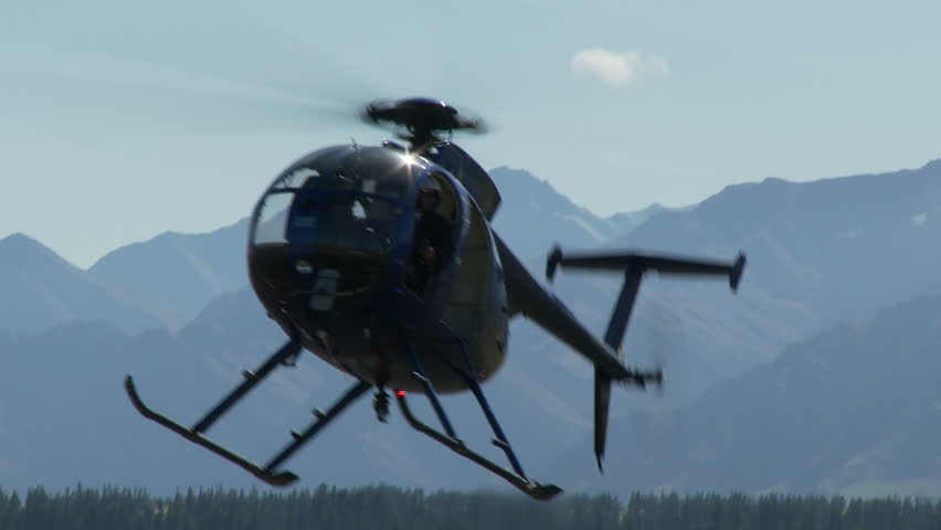 Helicopter hovers and then lifts off