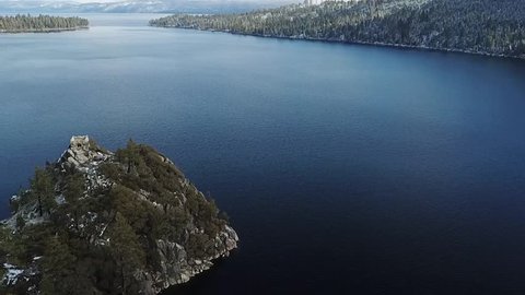 drone slowly flys over fannett island emerald bay lake tahoe california keeping the island in the bottom left of frame