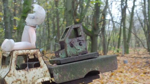 Broken childrens toy doll and car truck in abandoned ghost town Pripyat Ukraine after famous atomic catastrophe at nuclear power plant.