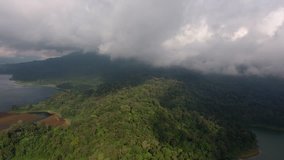 Bird's eye view of cloudscape over jungle environment changing weather in wet climate, video of white clouds height in air effecting climate above green rainforest in mountains tropical lands