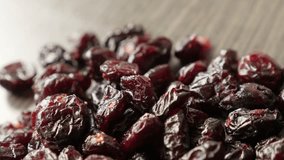 Shallow DOF healthy dehydrated cranberries on table 4K 2160p 30fps UltraHD footage - Red dried berries of Vaccinium oxycoccos 3840X2160 UHD panning video