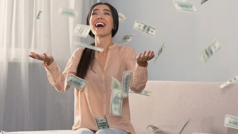Lots of cash falling on happy surprised girl, favorable bank loan terms, money