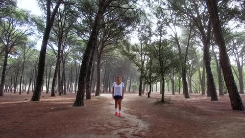 Girl running in forest  in the morning