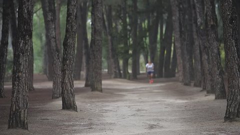 Girl running in forest  in the morning
