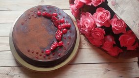 Big chocolate cake and beautiful bunch of pink roses 