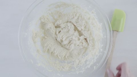 Mixing ingredients for sugar cookies in a glass bowl.