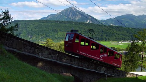 LUCERNE LUZERN, SWITZERLAND - JULY 2017: Pilatus mountain red funicular railcar train in Swiss Alps on Lake Lucerne in Switzerland.  Concept of travel Europe trip in summer.  