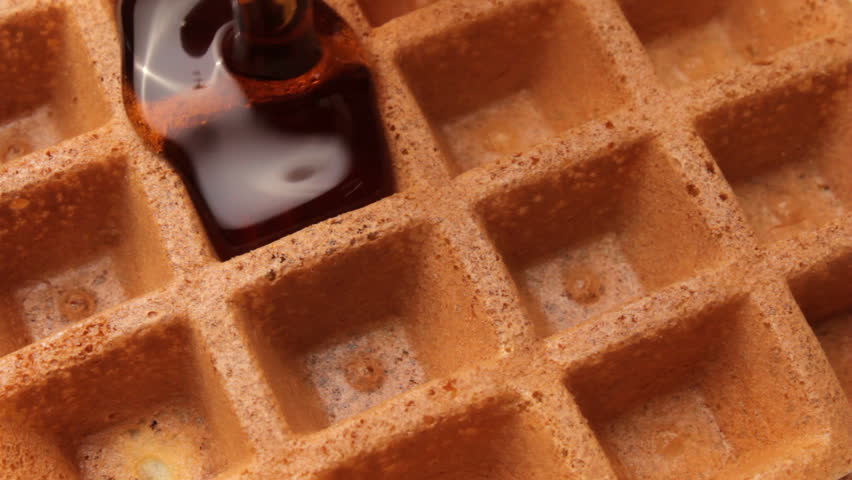 Maple syrup runs on golden brown waffle